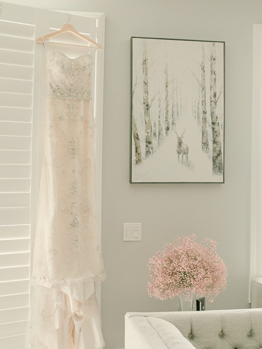 Élise embroidered ivory column dress on a hanger